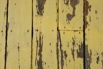 Old wooden background has peeling paint.