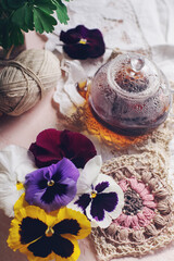 Obraz na płótnie Canvas Cozy morning with cup of tea and viola flowers