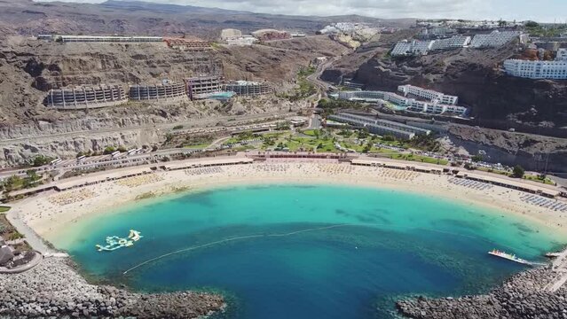 Aerial drone footage. Playa de Amadores, large cove with a white sand beach. Puerto Rico de Gran Canaria, Canary Islands, Spain.	
