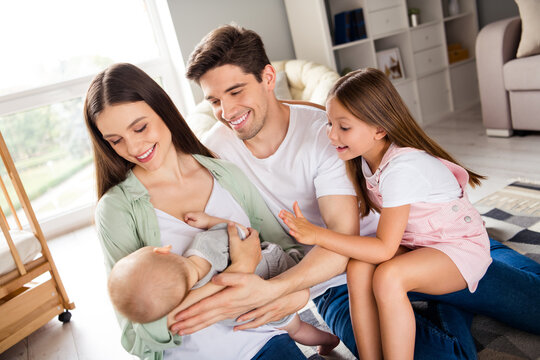 Photo of full lovely positive idyllic family hug embrace enjoy newborn free time morning indoors