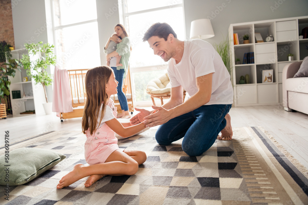 Sticker Photo of funny sweet husband wife little children father playing patty cake game smiling indoors room home house