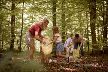 Caucasian family collect garbage from forest