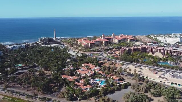 Aerial drone. Popular resort town of Meloneras, with hotels and restaurants, near the Maspalomas dunes in Gran Canaria, Canary Islands, Spain	
