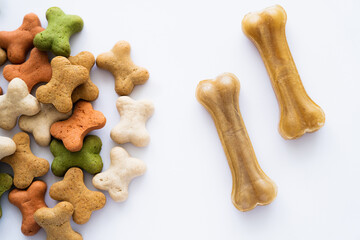 top view of crunchy bone shaped cookies and treats for dog isolated on white.