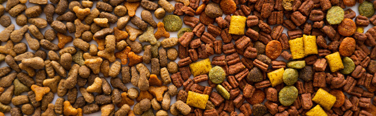 top view of dry pet food in different shapes as background, banner.