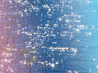 Bright sun glare on the water and pink glow