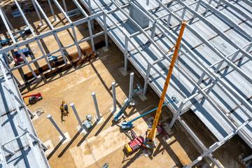 Factory Building. Aerial Industrial Construction Site with Cranes and Construction Equipment.