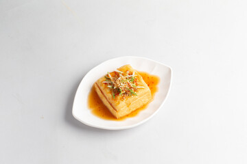 deep fried crispy tofu bean curd with Thai spicy chilli sauce halal snack menu on plate in white background