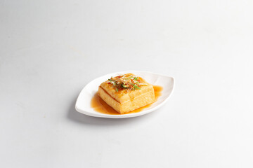 deep fried crispy tofu bean curd with Thai spicy chilli sauce halal snack menu on plate in white background