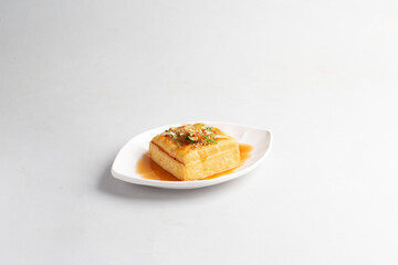 deep fried crispy tofu bean curd with Thai spicy chilli sauce halal snack menu on plate in white background