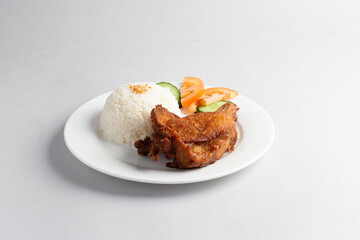 asian deep fried fresh crispy kampong chicken rice with cucumber and tomato in white background halal menu