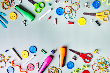 Various school supplies, notebooks, colored pencils, markers, scissors, thumbtacks, colored notebooks. Back to school.