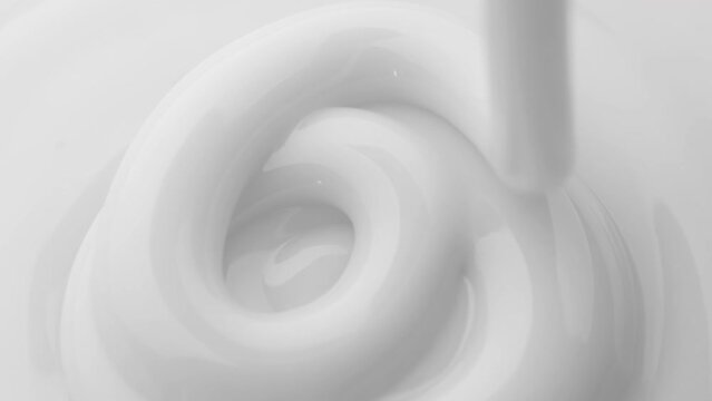 Pouring cream. Close-up shot.