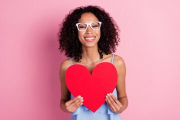 Photo of pretty cheerful person hold big red paper heart card symbol isolated on pink color background