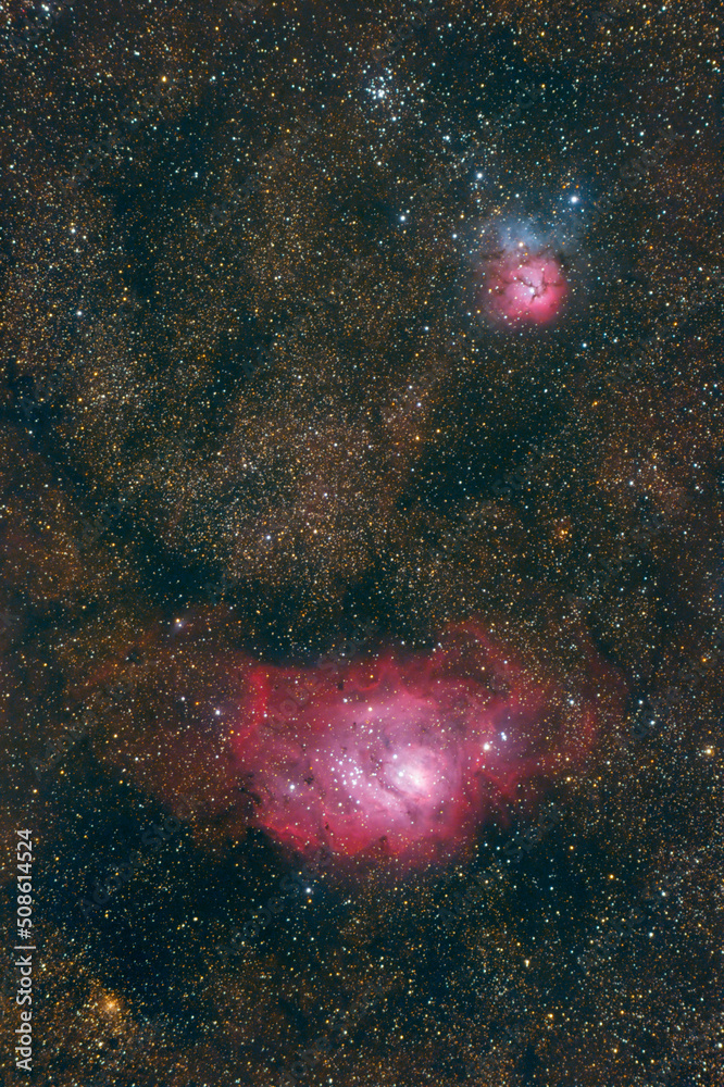 Wall mural the lagoon and triffid nebulae (m8) - (m20) in the constellation of sagittarius