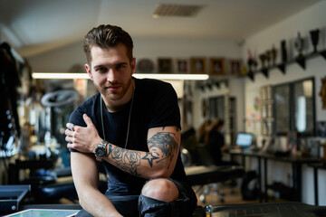 Portrait of young adult owner of tattoo salon