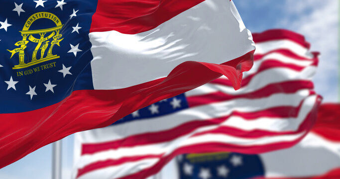 The Georgia state flag waving along with the national flag of the United States of America