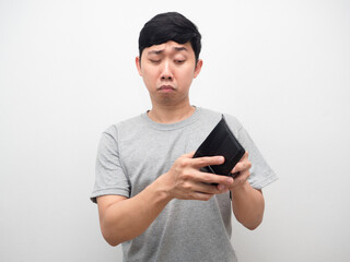 Poor man fear to looking at his wallet in hand