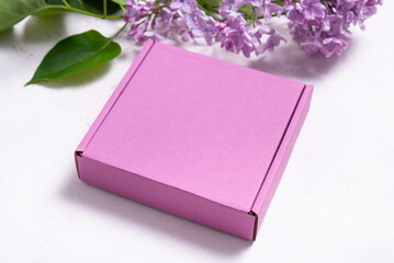 Brown cardboard box decorated with lilac branch