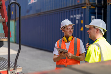 Professional workers team working together at warehouse container yard.
