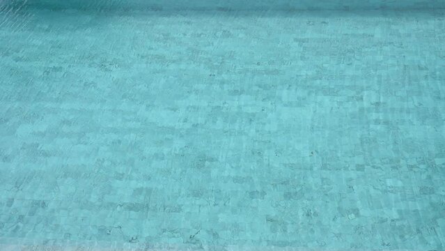 slow motion, clear water ripple surface in blue swimming pool