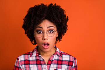 Portrait of impressed young lady open mouth speechless reaction isolated on orange color background