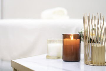 Place for relaxation in modern wellness center. candle towels massage table. Beautiful spa composition on massage table in wellness center