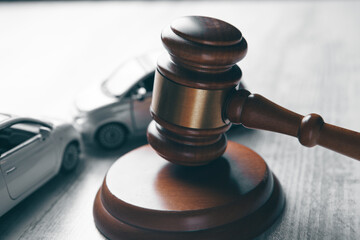 Model of car and gavel. Accident lawsuit or insurance, court case.