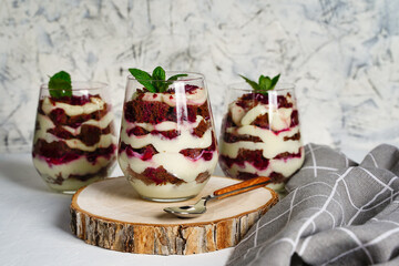 Three portions of cheesecakes in glass with cream cheese. Healthy homemade organic dessert.