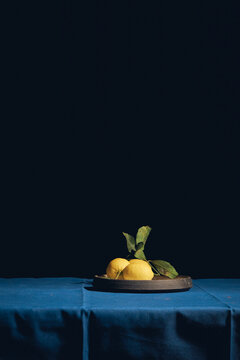 lemons on a table with a blue tablecloth