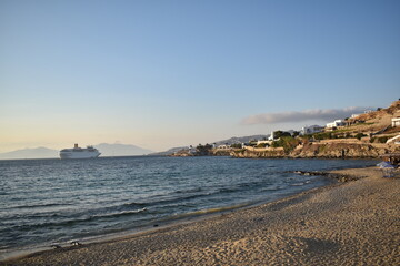 Calm ocean waves with ocean liners near city