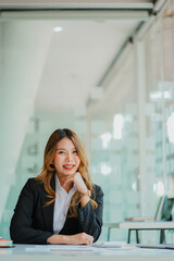 Obraz premium Accountant. Smiling beautiful Asian woman working on finances and calculators in office, accounting concept, vertical photo.
