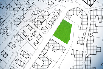 Imaginary cadastral map of territory with a free green land plot available for building construction - concept image