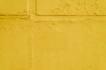Saturated yellow rough texture background, bright paint on concrete slabs outdoors