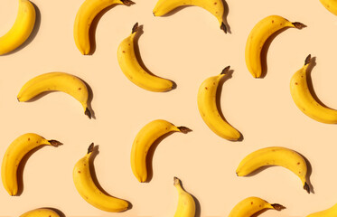 Yellow bananas pattern on a trendy beige background. Summer freshness, natural snack, organic. Healthy eating, raw food, vegan vitamins food concept. Bright abstract backdrop or wallpaper