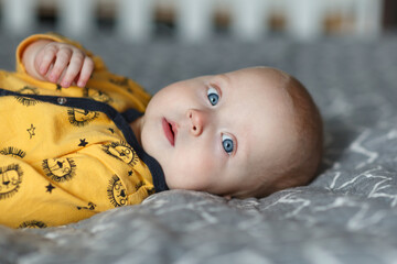 Cute 6 months baby lying on the bed