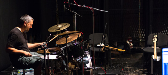 Fototapeta na wymiar Drummer playing drums in recording studio