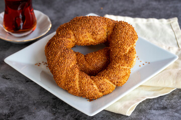 Sesame bagel. Turkish pastry product. Sesame bagel on a dark background. Close-up. local name susamli simit