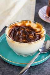 Rice pudding. Pastry product. Traditional Turkish cuisine delicacies. Milk dessert on a dark background. Close-up. Local name sutlac