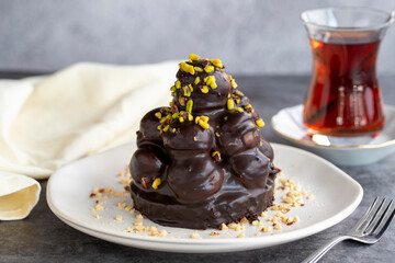 Profiterole cake. Pastry product. Profiterole cake on dark background. Close-up