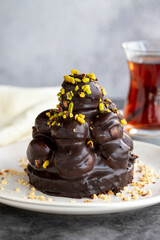 Profiterole cake. Pastry product. Profiterole cake on dark background. Close-up