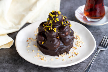 Profiterole cake. Pastry product. Profiterole cake on dark background. Close-up