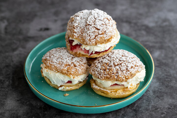 Cake with raspberry sauce and cream. pastry product. Snack cake on dark background. Close-up