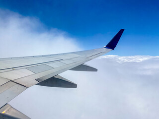 Clouds and airplane wing view from the plane window