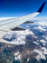 Clouds and airplane wing view from the plane window