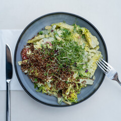 Green salad with red quinoa and sprouts