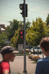 Red traffic light through people out of focus