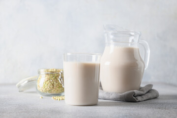 Obraz na płótnie Canvas Vegan green buckwheat milk in glass, plant based milk replacer.