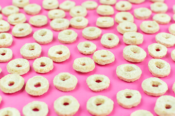 Background (texture) of oatmeal (corn) dry rings close-up. Quick healthy breakfast, add milk. Pattern.