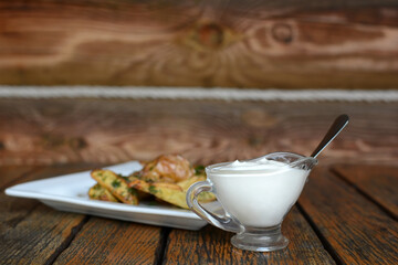 Appetizing fried potatoes with dill and sour cream